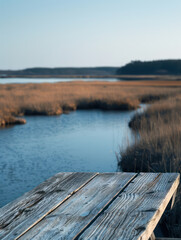 Calm Serenity Rustic Wooden Table Overlooking Serene River Landscape at Dusk, Breathtaking Nature Scene with Peaceful Water and Grassy Wetlands in the Background