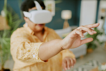 Close up photo of African American female hand touching virtual object in air, blurred background