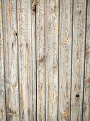 Fototapeta premium Texture of a wooden plank fence with vertical wood strips, gray brown wooden wall texture