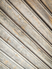 Fototapeta premium Texture of a wooden plank fence with diagonal wood strips, gray brown wooden wall texture