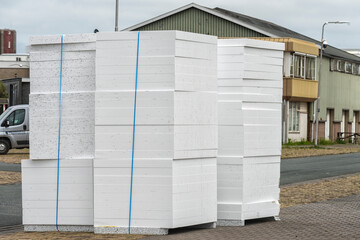 stacks of tied insulation boards for roof stand outside on the street