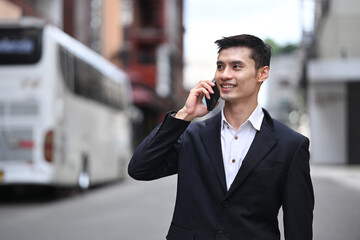 Businessman executive in formal clothes having phone conversation walking on city street talk