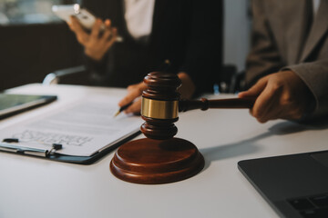 Lawyer, legal advisor, businessman brainstorming information on agreement details Business contracts in legal processing books for accuracy in contract documents. joint financial investment.