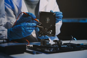 Obraz premium Close up of Technician measuring voltage electronic circuit board television, Service after sale fix electric equipment within insurance.