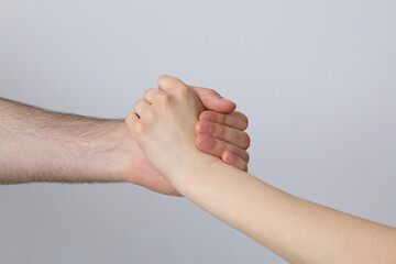 A female and a male hand make a handshake