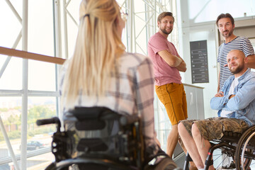 Inclusive group of friends with a person in a wheelchair engaging in conversation