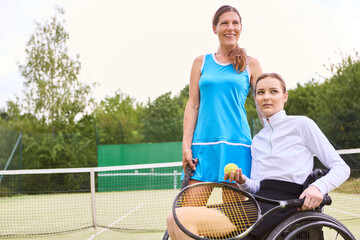 Person in wheelchair with friend playing tennis outdoors in Czech Republic