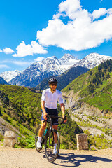 Fototapeta premium Male cyclist on the road in the Trans-Ili Alatau mountains.