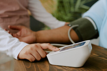 Close up photo of modern blood pressure tonometer in usage by nurse