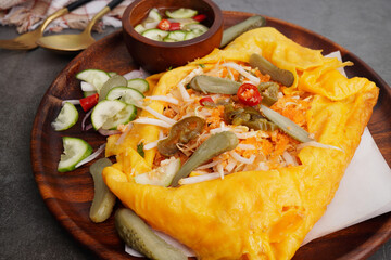 Vietnamese Savory Crepe and fresh cucumbers, sweet sauce, street food