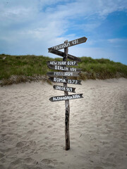 signpost with mileage indicationon the beach