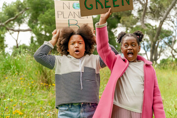Young activists with environmental signs in a park