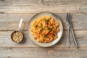 Rice with minced beef in tomato sauce in a plate. Top view