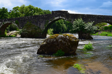 
Ponte Maceira, Spain - old Roman bridge over the water of the river Tambra in remote village on the Camino de Santiago de Compostella
