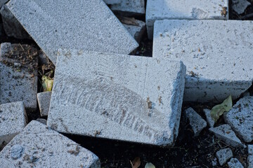 a pile of white pieces of broken bricks on the grey ground in the street