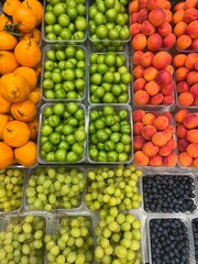 Grapes, peaches and cherry plums on the market