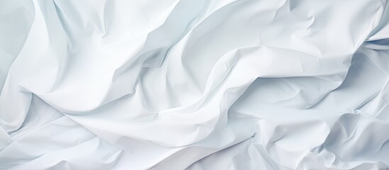 Obraz premium A crumpled white paper provides an abstract background for designers, featuring ample copy space image.