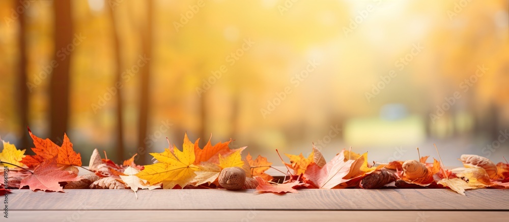 Poster autumn-themed wooden table with a blurred red and yellow leaves background sets the scene for a copy