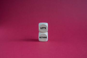 Concept words LET'S RETHINK written on beautiful wooden cubes. Beautiful red background. Business concept. Copy space.