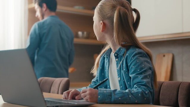 Family at home kitchen little daughter kid child girl schoolgirl confused with study need help learning e-learning laptop distant computer education writing homework difficult ask father for helping