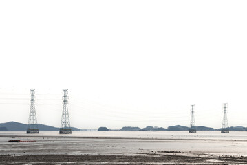 Obraz premium View of the power transmission towers on the sea