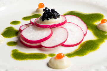 Gourmet appetiser with caviar and radish