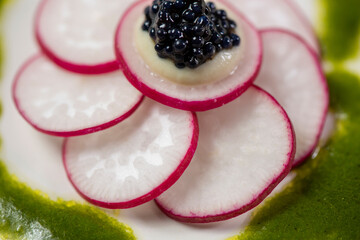 Gourmet appetiser with caviar and radish