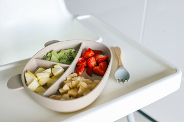 Baby eats food independently using self-feeding method, blw,