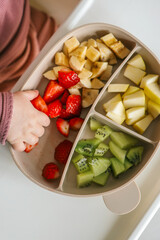 Baby eats food independently using self-feeding method, blw,
