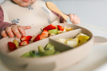 Baby eats food independently using self-feeding method, blw,