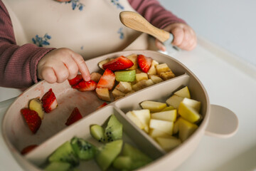 Baby eats food independently using self-feeding method, blw,