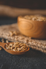 Sunflower seeds in wooden bowl on a rural background