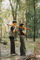 Fototapeta premium Asian couple sweet in tent inside on they camping trip, traveller relax and sleep togather in out door and camping trip