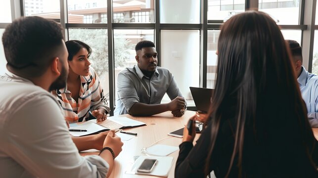 Diverse group of professionals engaged in an intense business meeting in a modern office setting.