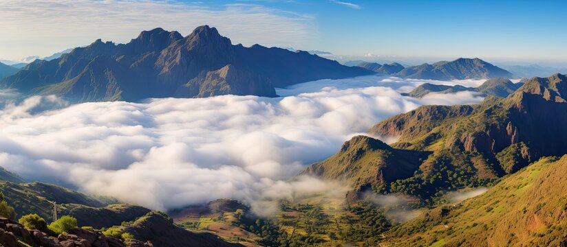 In Abha, Saudi Arabia, a stunning mountain view emerges above the clouds in a captivating landscape with a captivating copy space image.