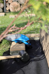 Laying an anti-weed mat in the garden together with paving stones and decorative pebbles.