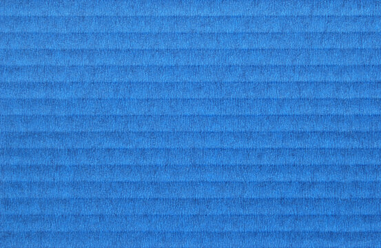 A sheet of blue corrugated cardboard texture as background