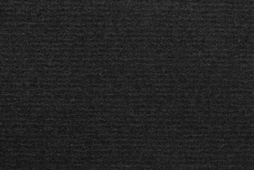 A sheet of black corrugated cardboard texture as background