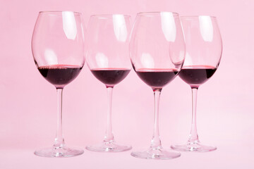 Many glasses of red wine at wine tasting. Concept of red wine on colored background. Top view, flat lay design