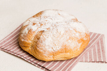 Assortment of freshly baked bread with napkin on rustic table top view. Healthy unleavened bread. French bread