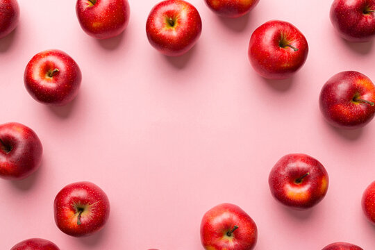 Many red apples on colored background, top view. Autumn pattern with fresh apple above view with copy space for design or text