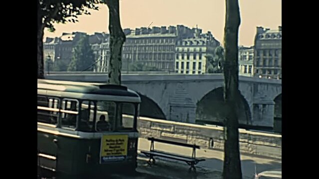 PARIS, FRANCE - CIRCA 1968: Palais Bourbon palace and road with vintage car and bus traffic at Pont Royal Bridge on Senna river, at Louvre Museum. Historic restored footage in 1960s.