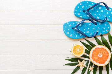 Top view composition of flip flops placed with beach accessories top view on table background. Tropical summer vacation concept Flat lay