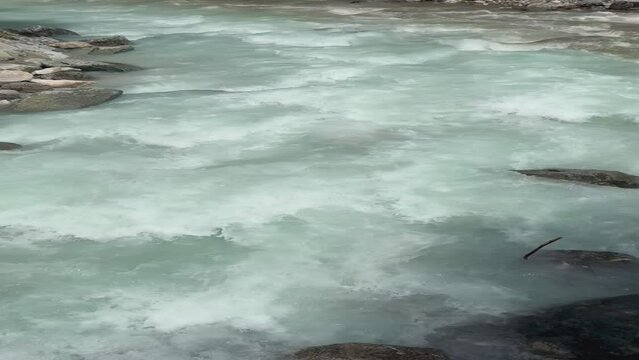 water from two different rivers flowing over rocks, teal and grey, Garmisch, Partnachklamm, Germany