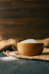 Sugar in a wooden bowl on burlap