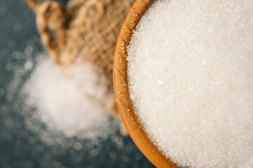Sugar in a wooden bowl on burlap
