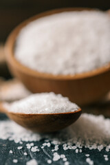 Pour salt into a wooden spoon, close-up