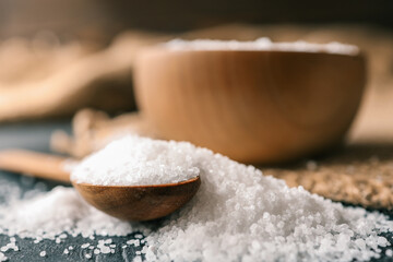 Pour salt into a wooden spoon, close-up
