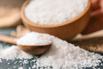 Pour salt into a wooden spoon, close-up