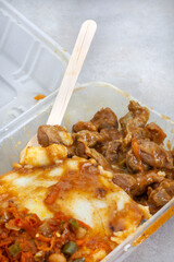 Traditional South African street food, gizzards and pap or maize meal and Chakalaka in take away...